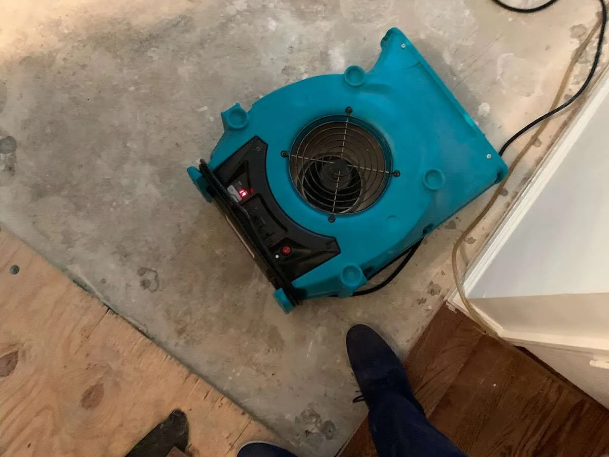Air mover drying subfloor during Commercial Water Damage Restoration in Clarendon Hills